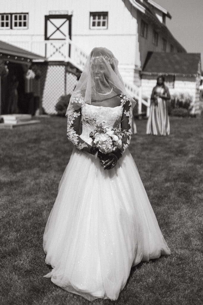 Photo of the bride walking to the first look with her dad at Post Family Farm in Hudsonville Michigan