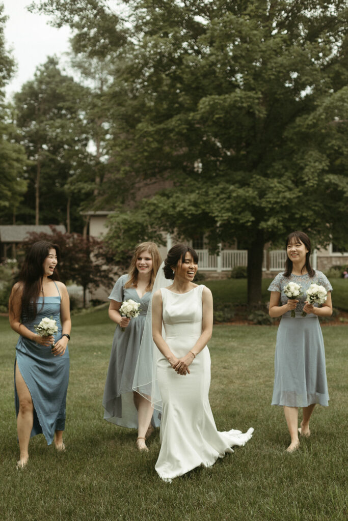 A bride walking with her bridesmaids. Editorial Styled Wedding Photo. Fine Art Wedding Photographer in Michigan 