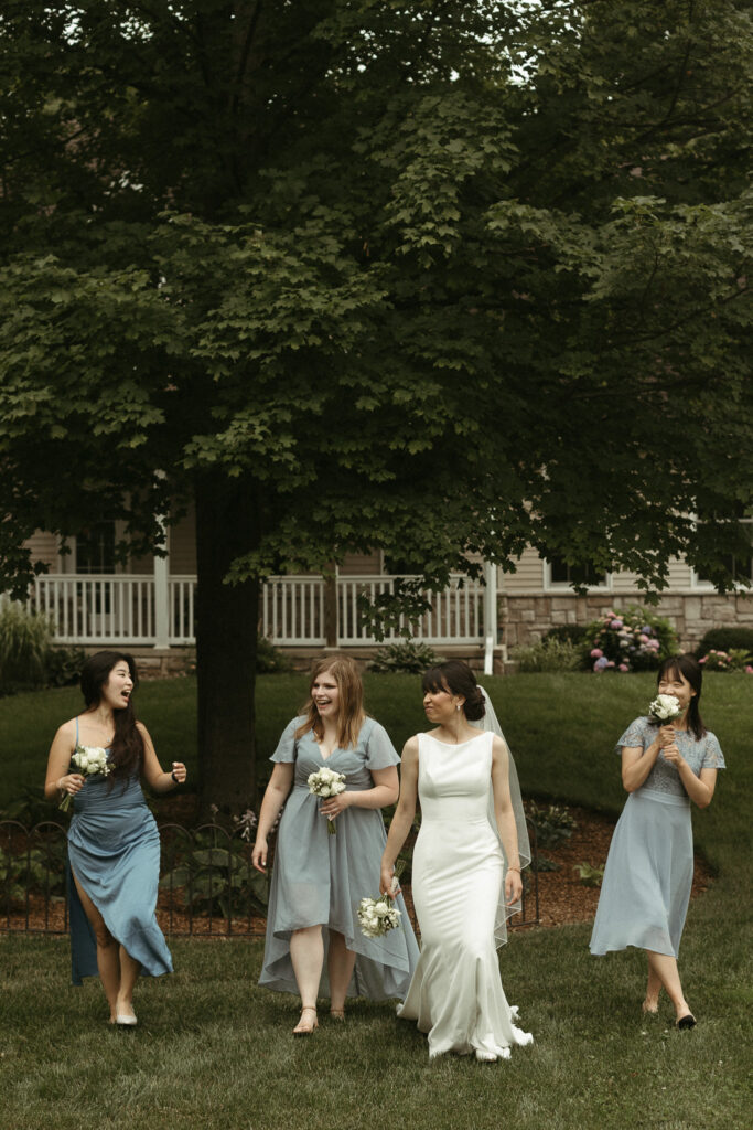 A bride walking with her bridesmaids. Editorial Styled Wedding Photo. Fine Art Wedding Photographer in Michigan 