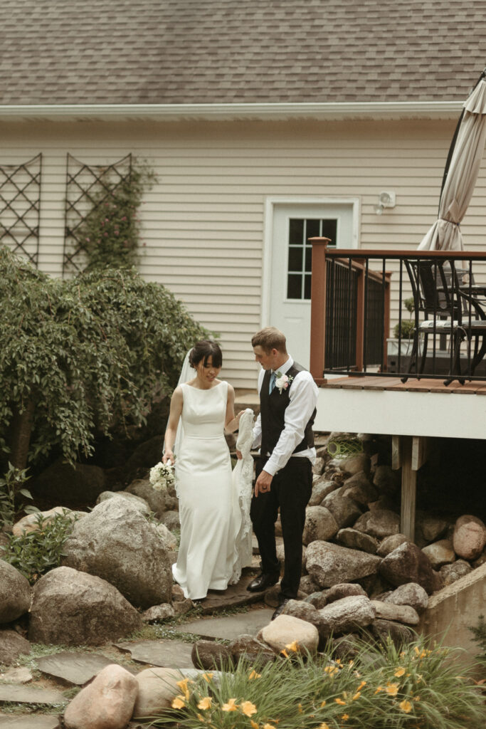 Photos of the bride and groom walking down steps together. Editorial Styled Wedding Photo. Fine Art Wedding Photographer in Michigan 
