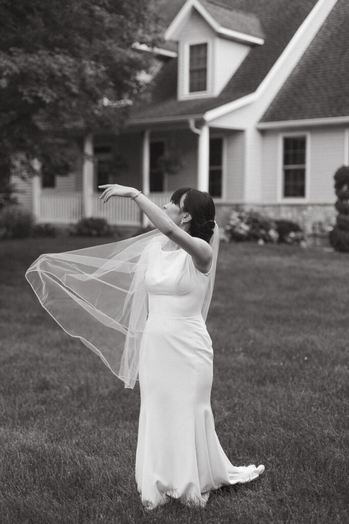 Editorial Styled Bride Portraits of the bride holding her veil up and walking. Editorial Styled Wedding Photo. Fine Art Wedding Photographer in Michigan 