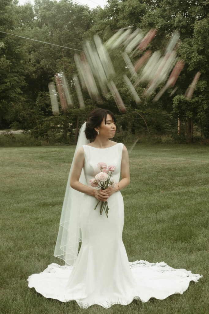  Editorial Styled Bride Portraits of the bride holding her veil up and walking. Editorial Styled Wedding Photo. Fine Art Wedding Photographer in Michigan 