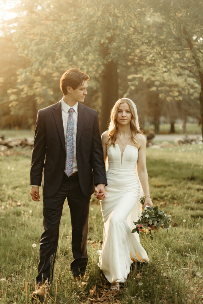 Bride and groom portraits in a dandelion field outside of a church parish in Michigan
