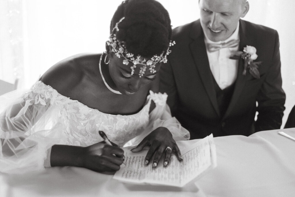 Bride signing the marriage license at Post Family Farm in Hudsonville Michigan