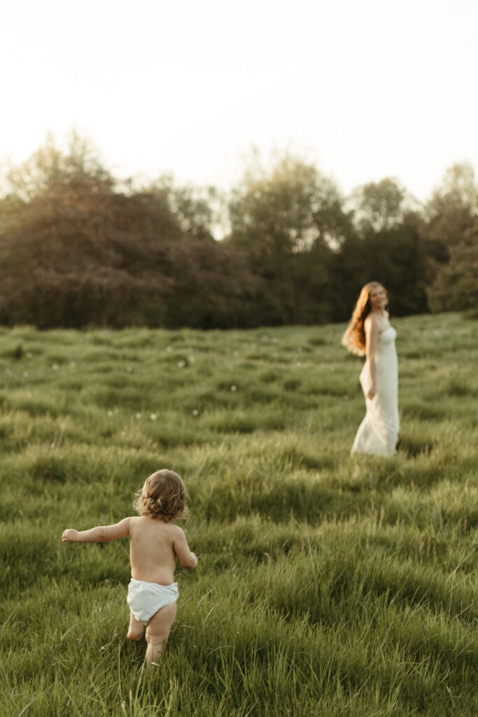 Photos of a woman and her son playing in a garden style wedding venue for their family photos.