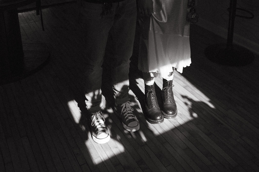 A black and white photo of a man and a woman's shoes