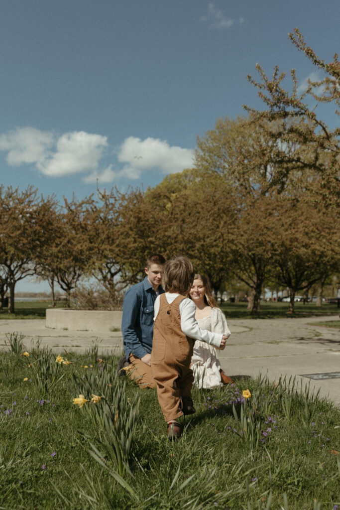 A family playing in flowers and in the grass on Belle Isle in Detroit Michigan