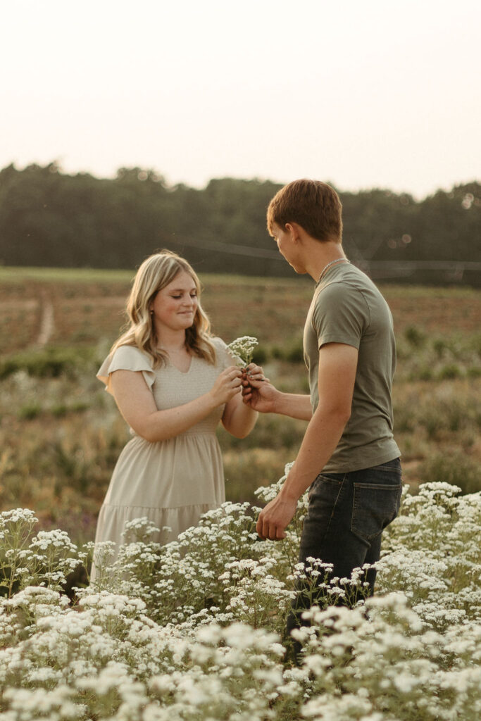 A man and a woman playing in a flower field in Michigan