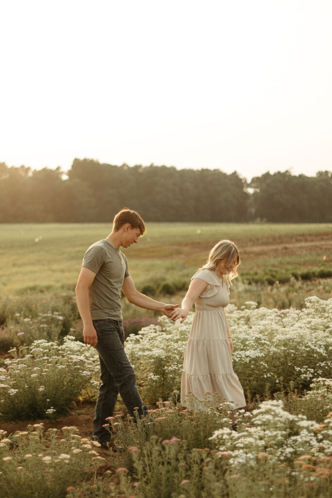 A man and a woman playing in a flower field in Michigan