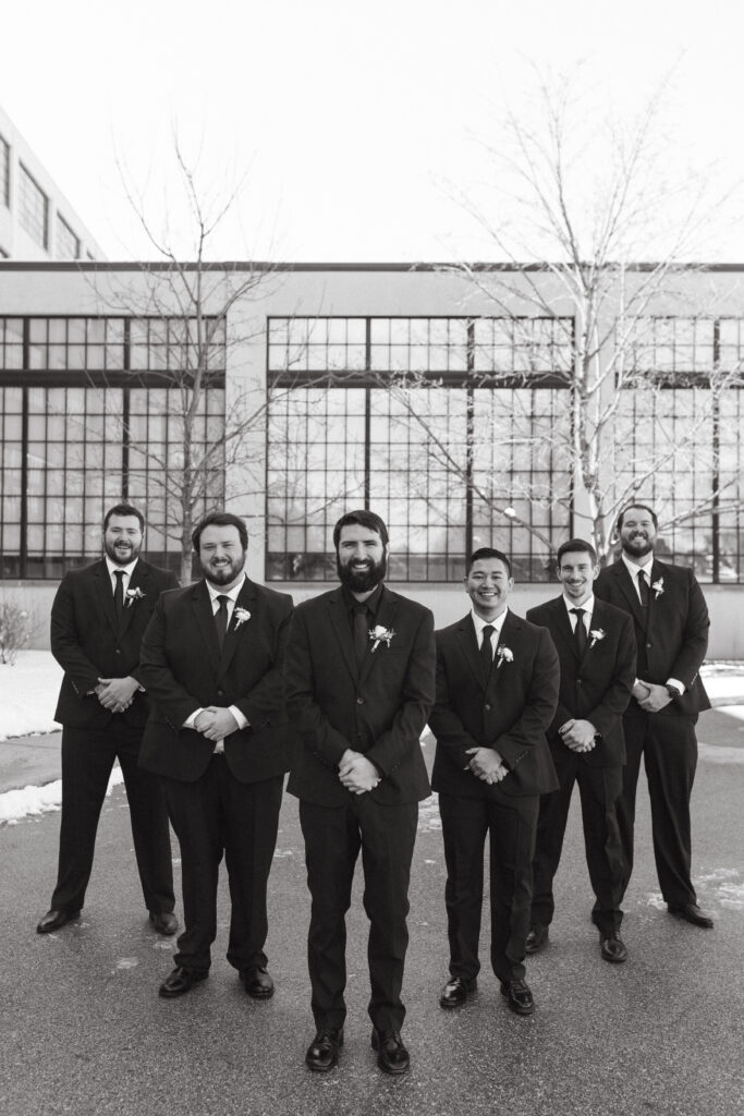 Photo of a groom and his grooms men walking towards the camera