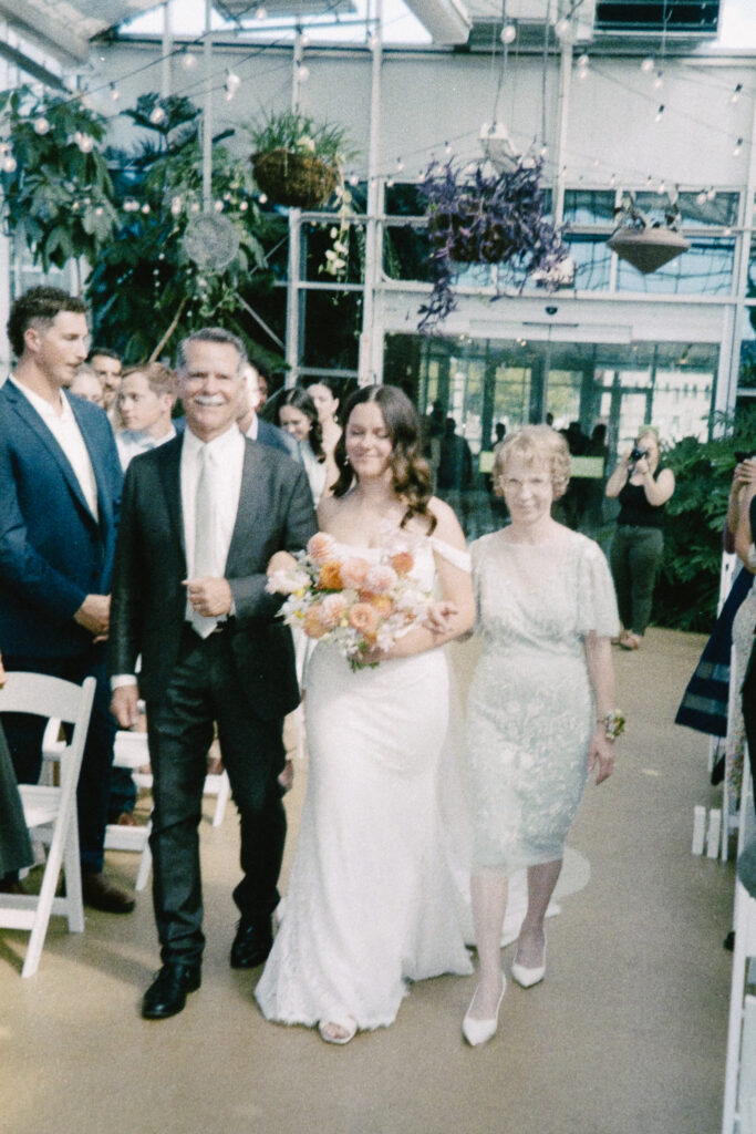 bride and groom during their wedding ceremony at a greenhouse wedding venue