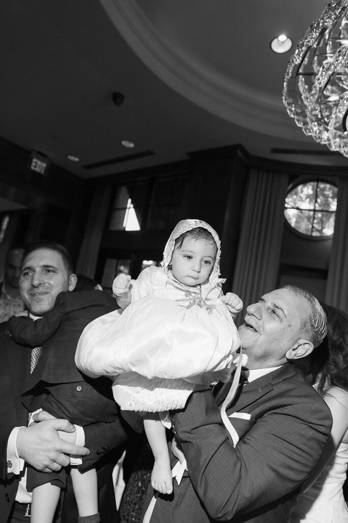 Candid celebration moments at The Townsend Hotel after baptism ceremony