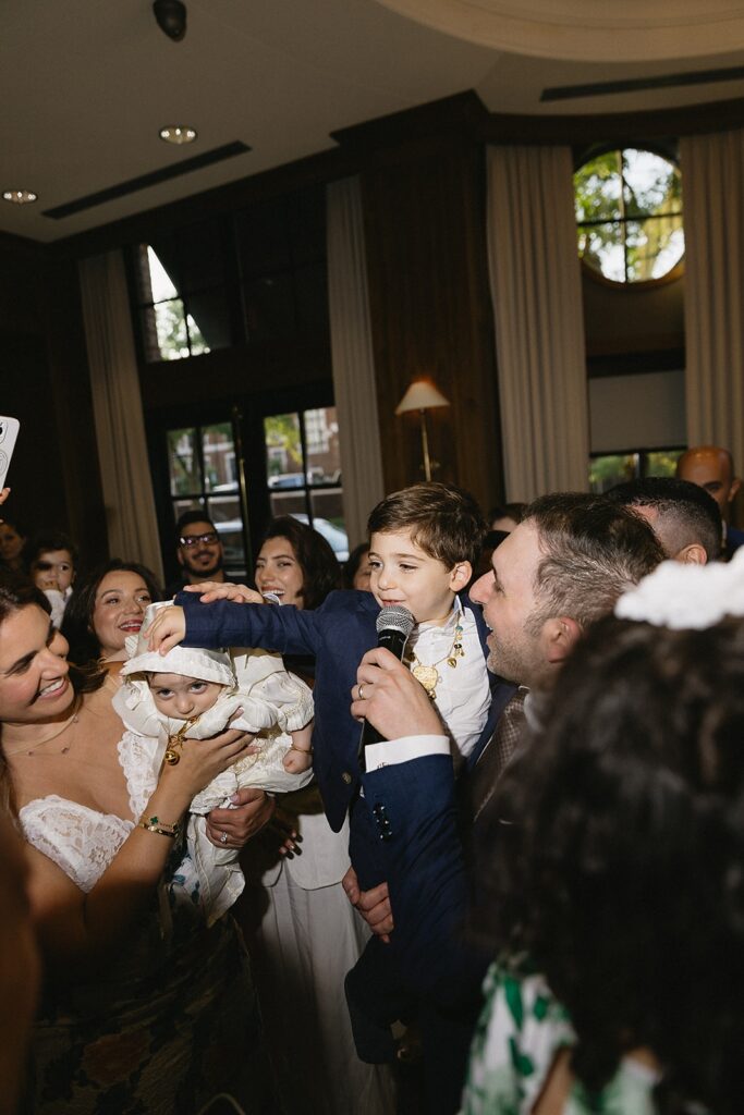 Candid celebration moments at The Townsend Hotel after baptism ceremony