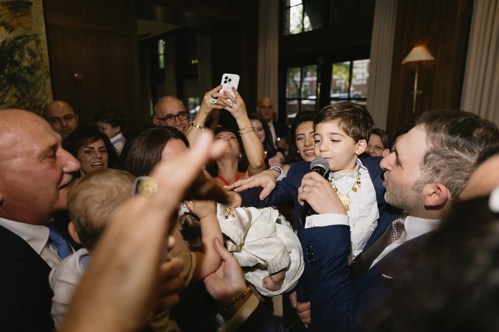 Candid celebration moments at The Townsend Hotel after baptism ceremony