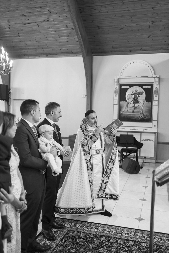 Family gathered for a baptism ceremony at Sts. Peter and Paul Syriac Orthodox Church
