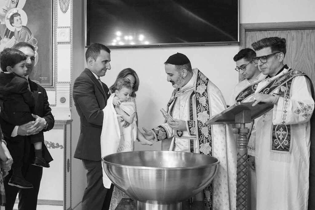 Family gathered for a baptism ceremony at Sts. Peter and Paul Syriac Orthodox Church